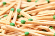 © marketlan - Close-up of a green match head against the background of randomly scattered matches
