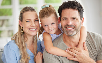 Happy family, portrait and bonding on a sofa with girl relaxing with her parents in their home. Man and woman enjoying quality time with daughter indoors, cheerful and relax in their house together