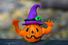 A Pumpkin Figurine In A Festive Hat With Raised Hands Is Trying To Scare. Halloween Decorations.