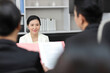 © feeling lucky - Human resources department managers sitting and interviewing female businesswoman applicant or candidate during job interview in modern office (Focus on female candidate). Business recruitment concept