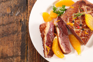 Wall Mural - roasted festive duck breast with orange slices