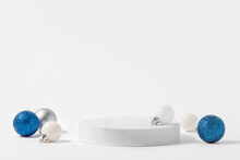 Cosmetic Background For Christmas And Winter Holiday. White Podium, Christmas Balls And Snow On White Background.
