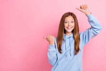 Photo Of Young Excited Positive Good Mood Cute Little Girl Wear Blue Hoodie Finger Pointing Empty Space Offer Sale School September Isolated On Pink Color Background