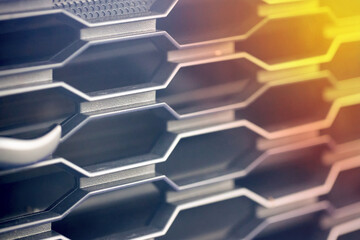 Grill grid of car macro chrome detail pattern background with sun flare. Radiator grille. Metal close-up texture background. Chrome grill of big powerful engine coolant macro.