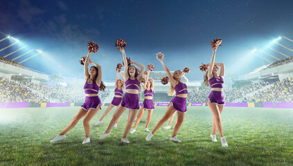 Wall Mural - Group of cheerleaders in action on  stadium in night