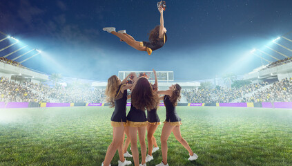 Wall Mural - Group of cheerleaders in action on  stadium in night