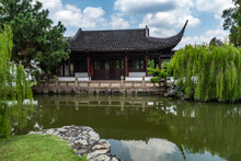 A Small Building Next To A Pond In The Suzhou Style Bonsai Garden At Jurong Lake Gardens, Singapore.