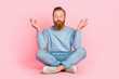 © deagreez - Full body portrait of content young man sitting floor closed eyes crossed legs meditate isolated on pink color background