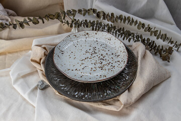 Wall Mural - Set of Ceramic Plates with Dried flowers on Calico. Ceramic tableware, Beautiful arrangement.