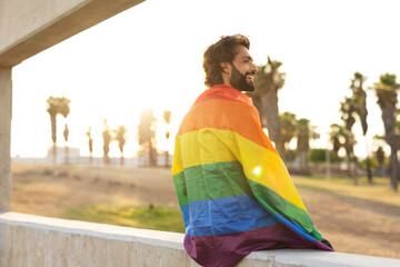 Wall Mural - Happy man with a pride flag. LGBT community.