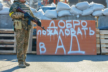 Welcome To Hell Inscription On A Wooden Shield At The Kyiv Checkpoint .
