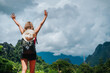 © Vilaysack - person jumping in the mountains, Mountain travel girl enjoying the wonderful view of the sunrise