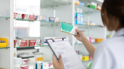 Pharmacist women are supplying prescription drugs to customers, Pharmacists work in a pharmacy, Drug store shelf with prescription medication, Clipboard at the hospital pharmacy, Community Pharmacy.