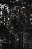 Fototapeta  - Eastern special forces soldier with rifle in the jungle
