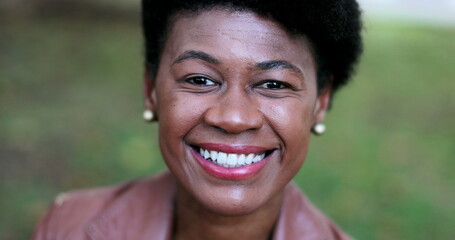 Wall Mural - Portrait black African woman smiling outside