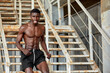 © Georgii - Sport Motivation. Black Male Athlete Running Up On Urban Stairs Outdoors, Enjoying Morning Workout, With Free Space