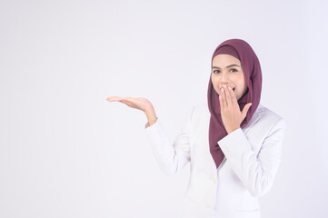 Wall Mural - Beautiful muslim business woman wearing white suit with hijab in studio.