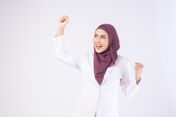 Wall Mural - Beautiful muslim business woman wearing white suit with hijab in studio.