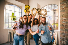 Group Of Friends At A Party Celebrate Happy New 2023 Year With Elegant Inflatable Gold Text - People Have Fun Together At Home