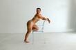 © Erin Brant/Stocksy - Curvy woman poses with clear chair