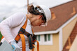 © ByLorena/Stocksy - Roofer builder woman