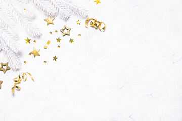 Wall Mural - Festive Christmas border with white fir tree branches and golden decorations on white marble background top view, copy space for your text.