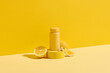 © Marc Tran/Stocksy - Mock up. A yellow plastic jar and lemon on a yellow wooden