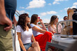 © Tessy Morelli/Stocksy - Tourists on holidays enjoying a yacht trip on the Tagus River Lisbon