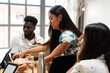 © Valentina Barreto/Stocksy - Coworkers having cake in office
