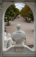 Wall Mural - Paris, France - 09 16 2022: Tuileries garden. Marble sculpture of two men and a woman looking at the bust of Waldeck Rousseau