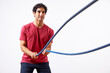 © ALTO IMAGES/Stocksy - Strong sportsman exercising with battle ropes