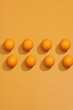 © Marc Tran/Stocksy - Colorful fruit pattern of fresh orange on yellow background.