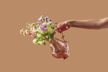 Old-fashioned Copper Jug With Blooms Held By Woman.