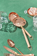 Copper Ladle And Skimmer On Green Linen Tablecloth.