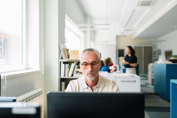 Middle-aged Man Working in Office