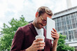 © Studio Firma/Stocksy - Man with Coffee and Digital Tablet Outdoors