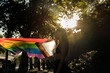 © Malquerida Studio/Stocksy - Woman waving LGBTQIA+ flag