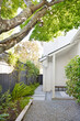 © Trinette Reed/Stocksy - Exterior side yard landscaping and walkway of a home
