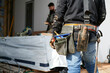 © Rowena Naylor/Stocksy - Builder wearing tool belt