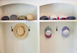 © Trinette Reed/Stocksy - Hats hanging in mudroom of home entrance