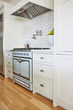 © Trinette Reed/Stocksy - Stove oven in modern design farmhouse kitchen home