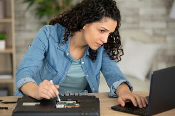 young technician woman repairing computer