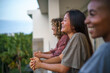 © Jovo Jovanovic/Stocksy - Three girlfriends laughing while spending time on balcony
