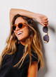 © VICTOR TORRES/Stocksy - Stylish cheerful woman in sunglasses