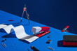 © AUDSHULE/Stocksy - office supplies on blue set up