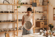 © Brkati Krokodil/Stocksy - Portrait Of A Female Entrepreneur Holding A Ceramic Bowl