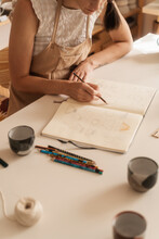 Anonymous Female Artist Designing Pottery In The Ceramics Studio