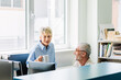 © Studio Firma/Stocksy - Man and Woman Talking in Office
