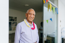 Senior Man Posing With Party Decorations
