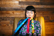 © BONNINSTUDIO/Stocksy - Woman blowing colorful noisemakers during party